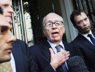 Group of men in suits speaking outside.