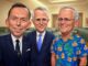 Three men in suits, one in floral shirt.