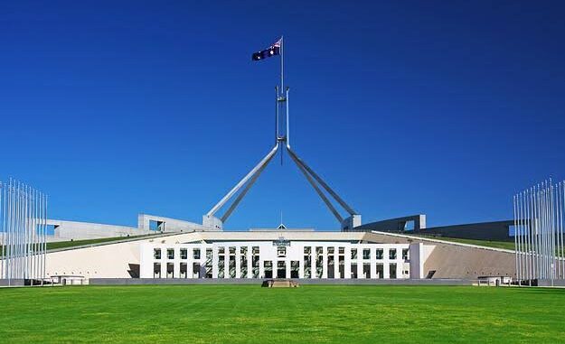 Parliament House with Australian flag, sunny day. Parliament House with Australian flag, sunny day.
