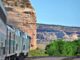 Train traveling through scenic desert landscape.