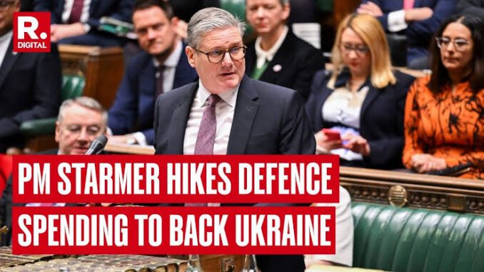 Politician speaking in parliamentary session, headline displayed.