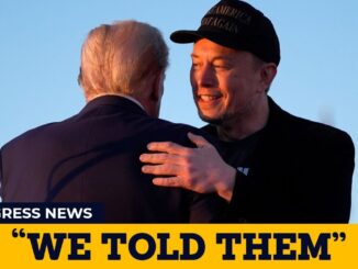 Two men embracing at public event.