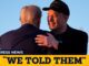 Two men embracing at public event.