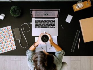 Person working at a desk with laptop.