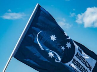 Australian Workers' Union flag against blue sky.