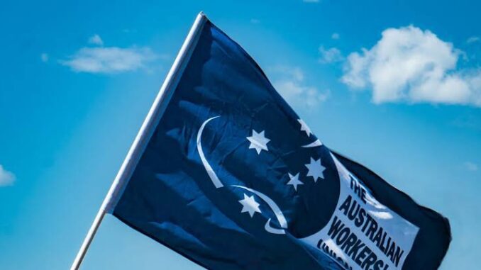 Australian Workers' Union flag against blue sky.