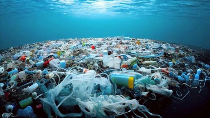 Ocean plastic pollution floating on water.