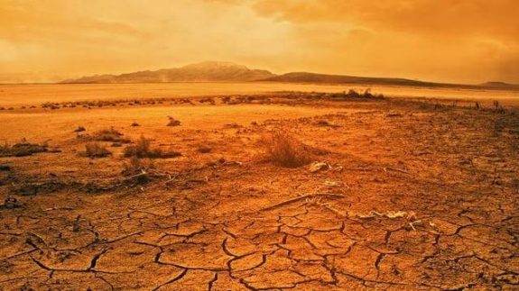 Arid desert landscape with cracked earth.