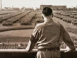 A leader addressing a large military assembly.