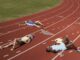 Runners lying exhausted on a track.