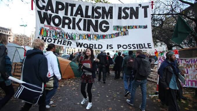 Protesters under "Capitalism Isn't Working" banner. Protesters under "Capitalism Isn't Working" banner.