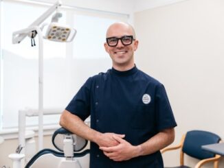 Dentist smiling in a dental office.