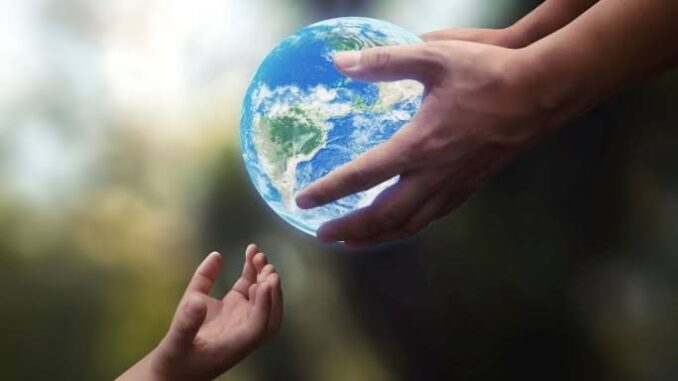Hands passing a globe, symbolizing unity.