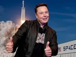 Man giving thumbs up near rocket launch.