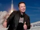 Man giving thumbs up near rocket launch.
