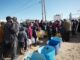People in line for water distribution.
