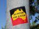 Sticker reading "No Room for Racism" on pole.