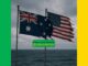 Australian and American flags against cloudy sky.