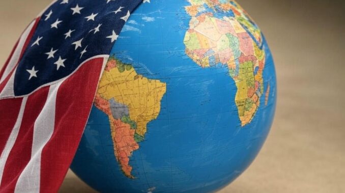 Globe partially covered by American flag.