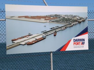Sign displaying Darwin Port illustration behind fence.