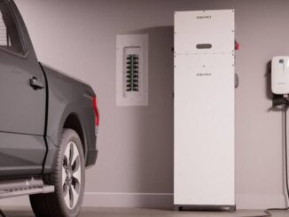 Truck charging in a garage with equipment.