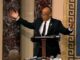 Person speaking passionately at a podium.