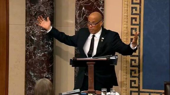 Person speaking passionately at a podium. Person speaking passionately at a podium.