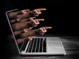 Hands emerging from laptop screen, pointing outward.
