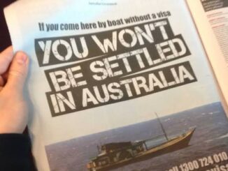 Hand holding newspaper with Australian immigration warning.