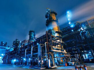 Industrial plant at night with bright lights.