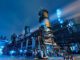 Industrial plant at night with bright lights.