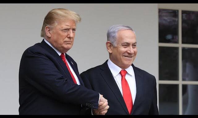 Two men shaking hands, wearing suits.