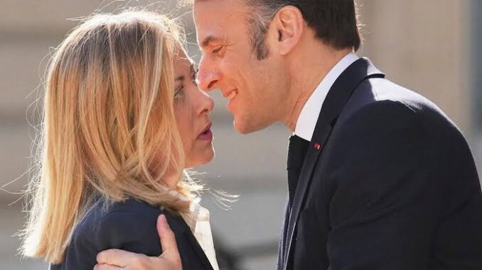 Two people greeting each other closely.