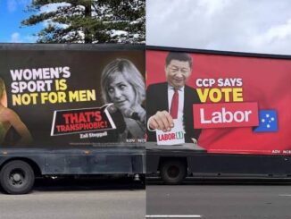 Two trucks with political advertisement banners.