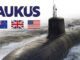 Submarine with AUKUS text and three flags.