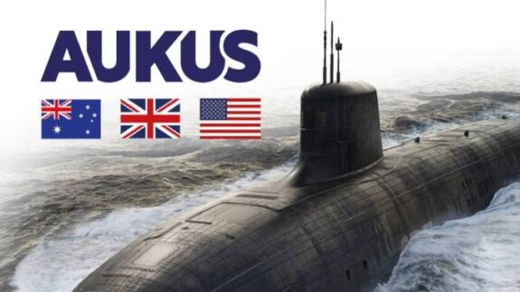 Submarine with AUKUS text and three flags. Submarine with AUKUS text and three flags.