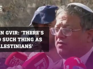 A man speaks to reporters, denying any wrongdoing against Palestinians.