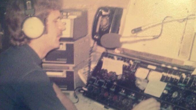 Person speaking into a microphone in a vintage radio studio. Person speaking into a microphone in a vintage radio studio.