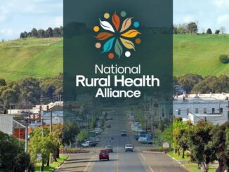 Road leading to a town with a National Rural Health Alliance logo overlay.