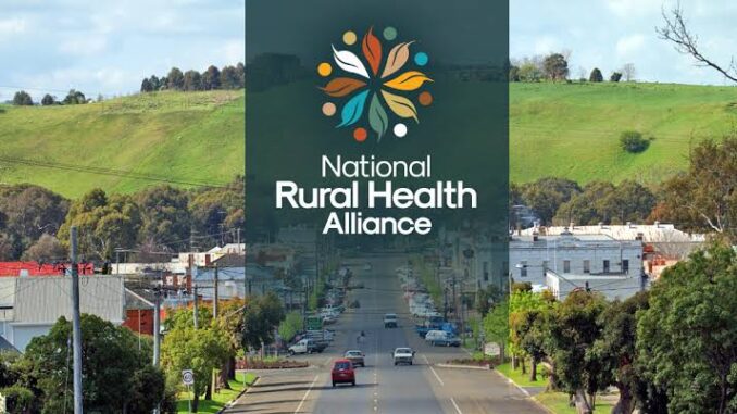 Road leading to a town with a National Rural Health Alliance logo overlay.