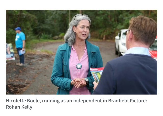 Candidate speaking to a reporter outdoors during a campaign event.