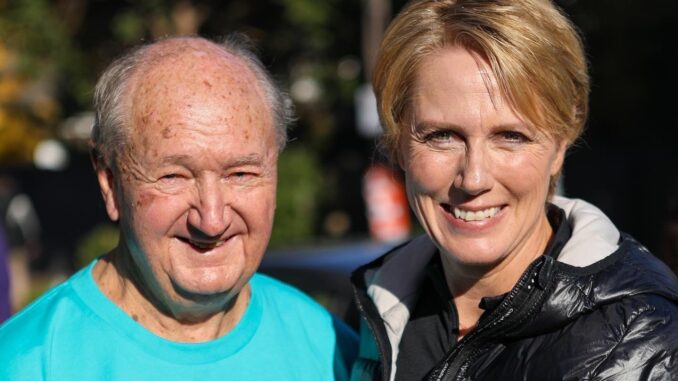 Smiling elderly man and middle-aged woman outdoors on a sunny day. Smiling elderly man and middle-aged woman outdoors on a sunny day.