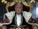 Man dressed as a king sitting on a throne.