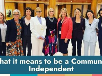 Group of professional women standing together in a conference room.
