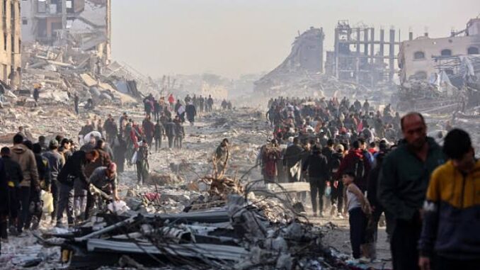 People walk through a large disaster site with rubble and debris. People walk through a large disaster site with rubble and debris.