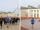 People jogging near a modern building with a wind turbine in the background.