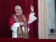 A pope in ornate robes waving from a balcony.