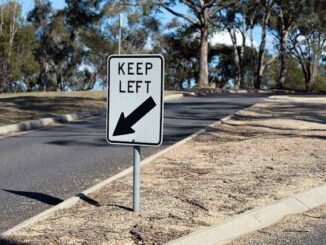 Road sign instructing drivers to keep left.