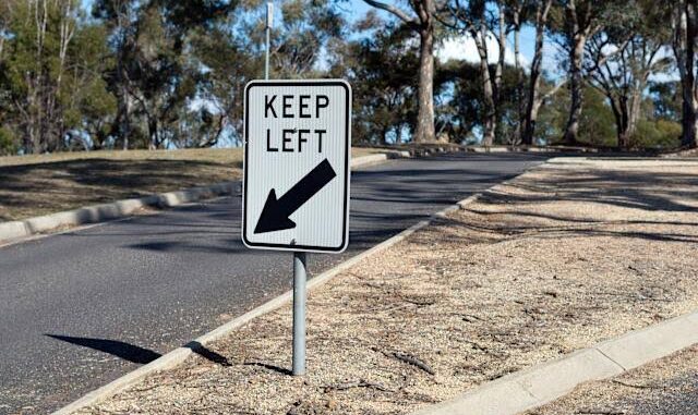 Road sign instructing drivers to keep left.