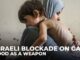 A mother holds her malnourished child amid crisis.